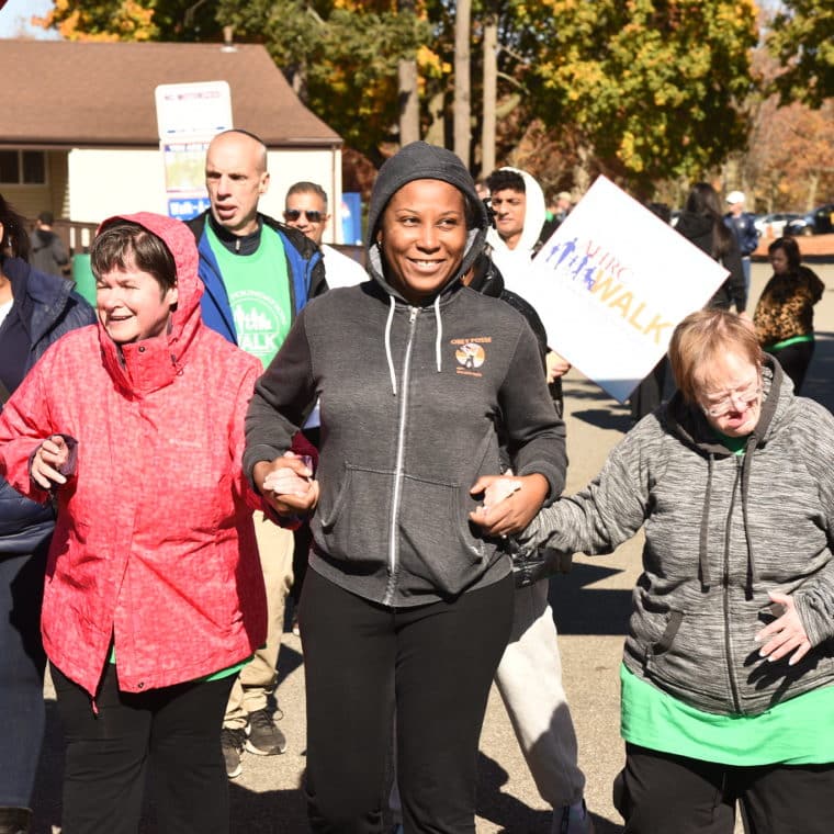 People supported and staff members walk at the Annual AHRC Foundation Walk at Eisenhower Park
